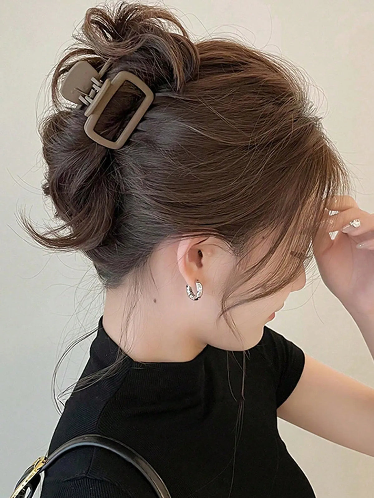 A woman is shown with her hair styled in an updo using a square lightweight hair claw clip set.