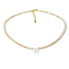 A delicate mother of pearl necklace with crystal accents featuring an initial charm.