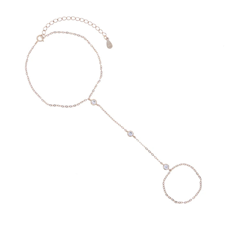 A delicate geometric bezel charm bracelet made of 925 sterling silver with a chain and various charms.