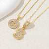 Gold-toned necklace set featuring CZ crystal pendants shaped like the letter S and a circular design.