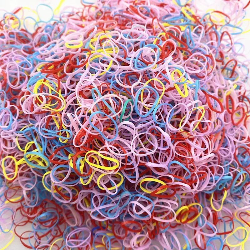 A pile of colorful disposable hair scrunchies in various shades including pink, red, blue, and yellow.