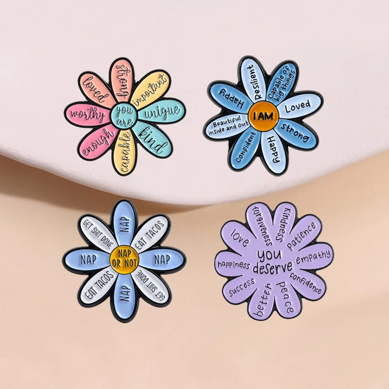 A set of enamel flower brooches featuring inspirational words like I am loved and you are important.