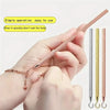 A hand is demonstrating a precision jewelry tool kit for clasps and closures, showing various colored tools.