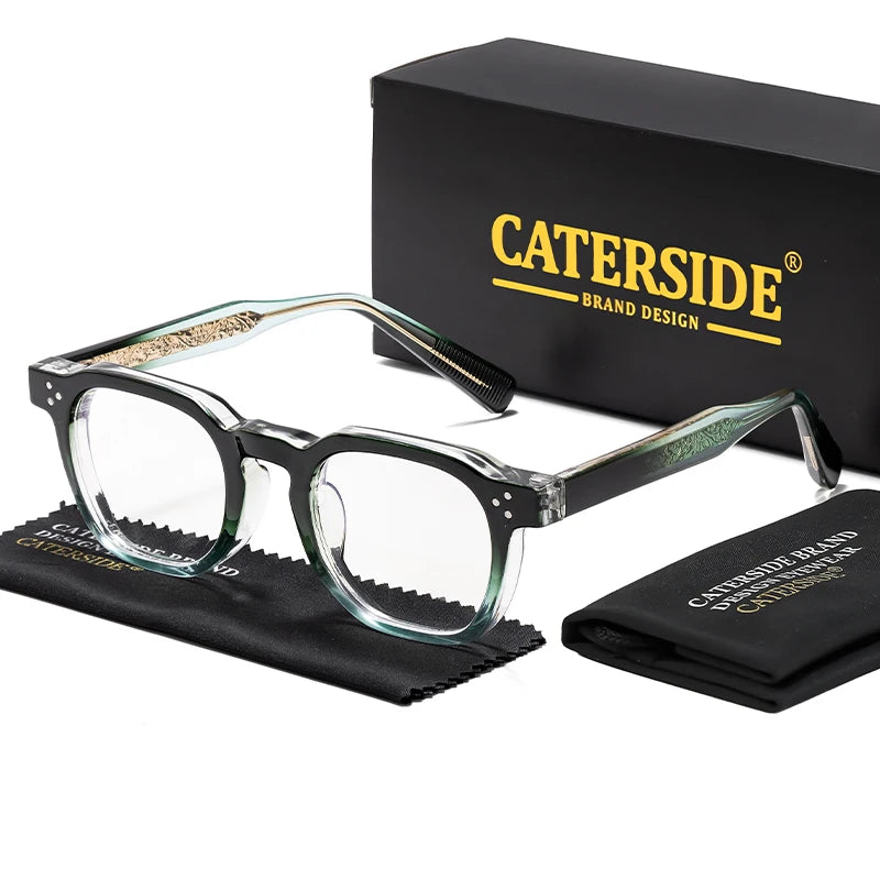 A pair of clear-framed retro square anti-blue light eyeglasses resting on a black cloth next to a black box labeled CATERSIDE
