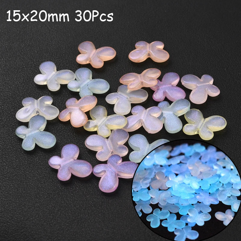 A collection of 30 translucent glow-in-the-dark acrylic flower-shaped beads scattered on a dark surface.