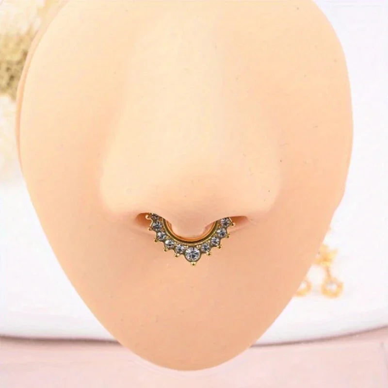A set of six faux septum and nose rings displayed against a light peach-colored skin tone.