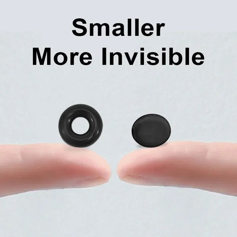 A hand holds two small black silicone ear hooks, demonstrating their size and invisibility.