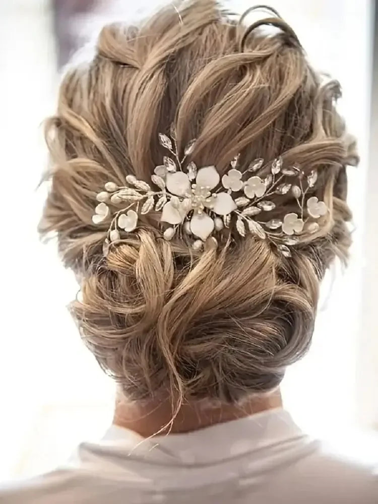 A woman's hair styled in an elegant updo with a golden leaf shaped pearl flower hairpin comb.