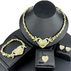 A gold heart crystal jewelry set featuring a necklace and bracelet displayed on a black stand.