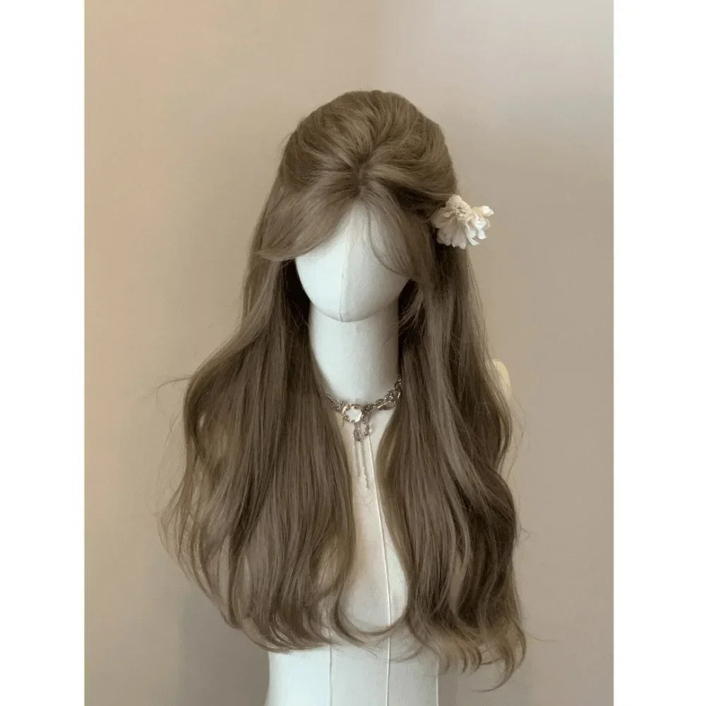 A long, wavy brown wig displayed on a mannequin with a white top.