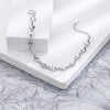 A silver double heart charm bracelet displayed on a white background.