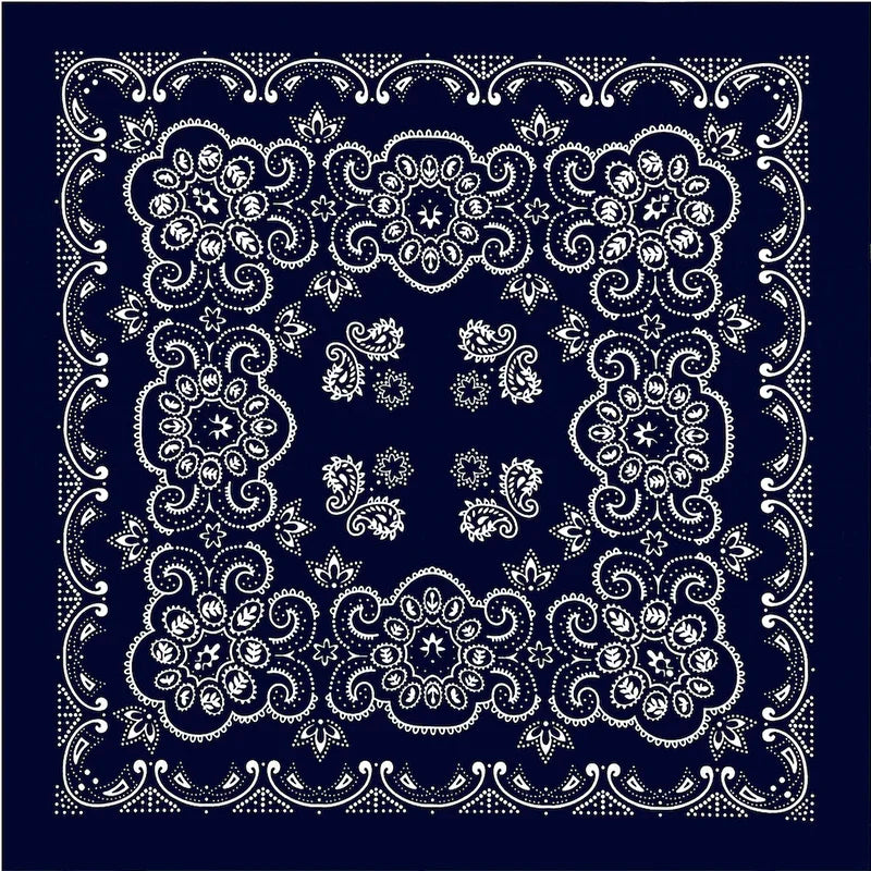 White intricate floral pattern embroidery on a dark blue fabric square