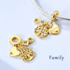 Gold-tone charm bracelet featuring a heart and tree pendant on a silver chain.