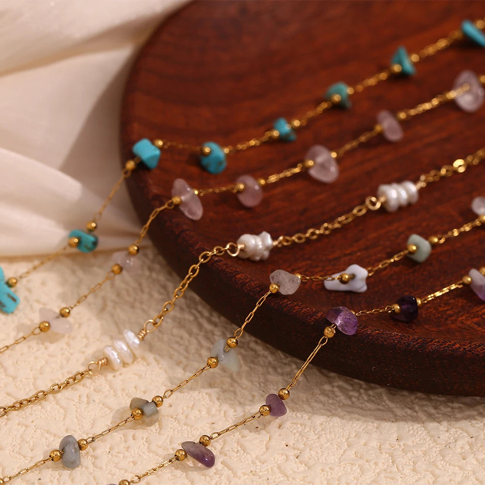 Gold plated foot chains featuring various crushed stone beads in shades of blue, pink, and purple
