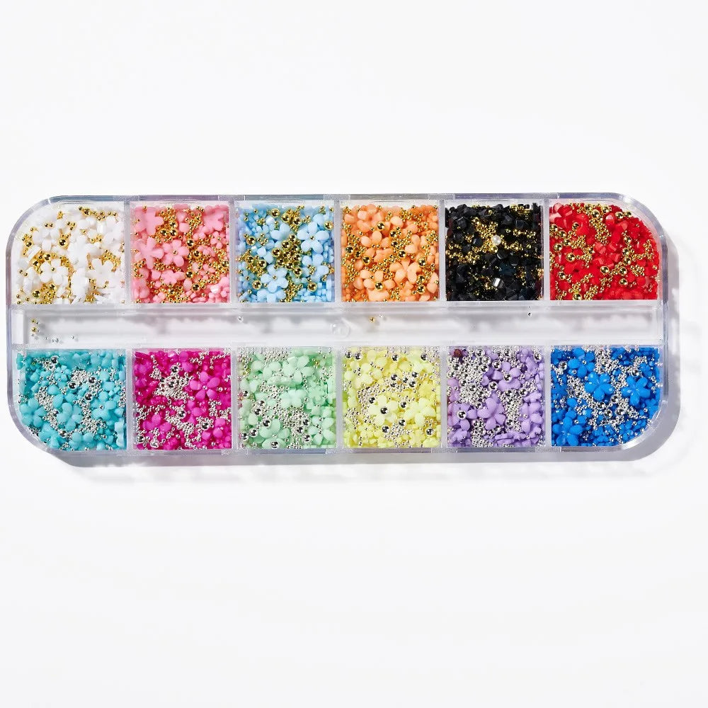 A collection of colorful butterfly bow nail charms in various shades including pink, white, blue, and gold.