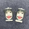 Pair of black fingerless knit gloves featuring a retro printed face design.
