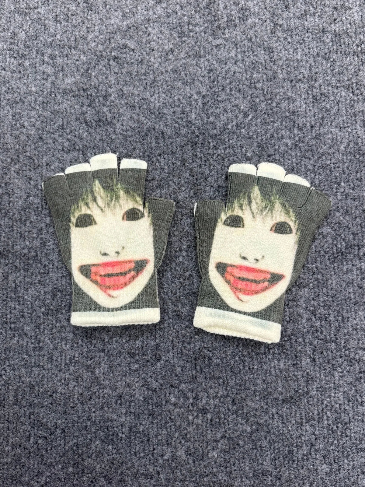 Pair of black fingerless knit gloves featuring a retro printed face design.