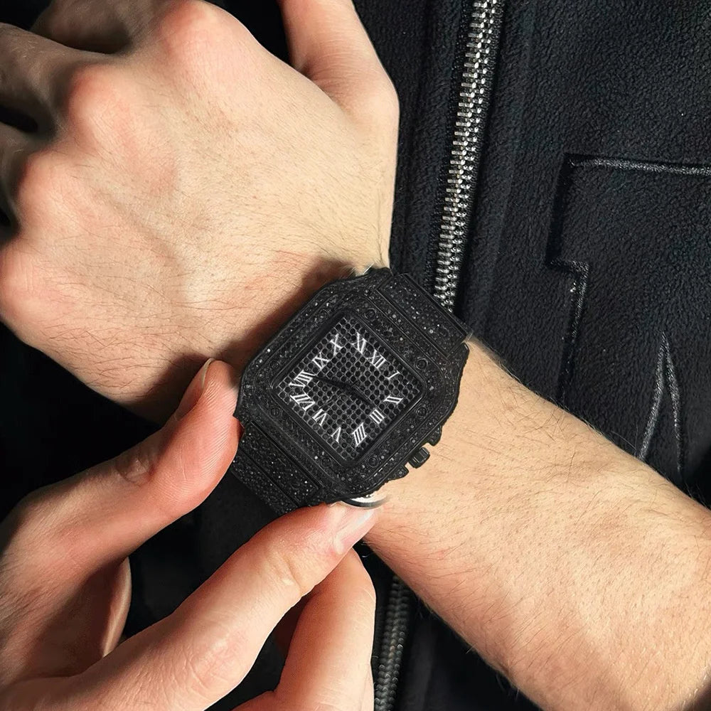 A hand is putting on a black diamond crystal quartz wristwatch for men.