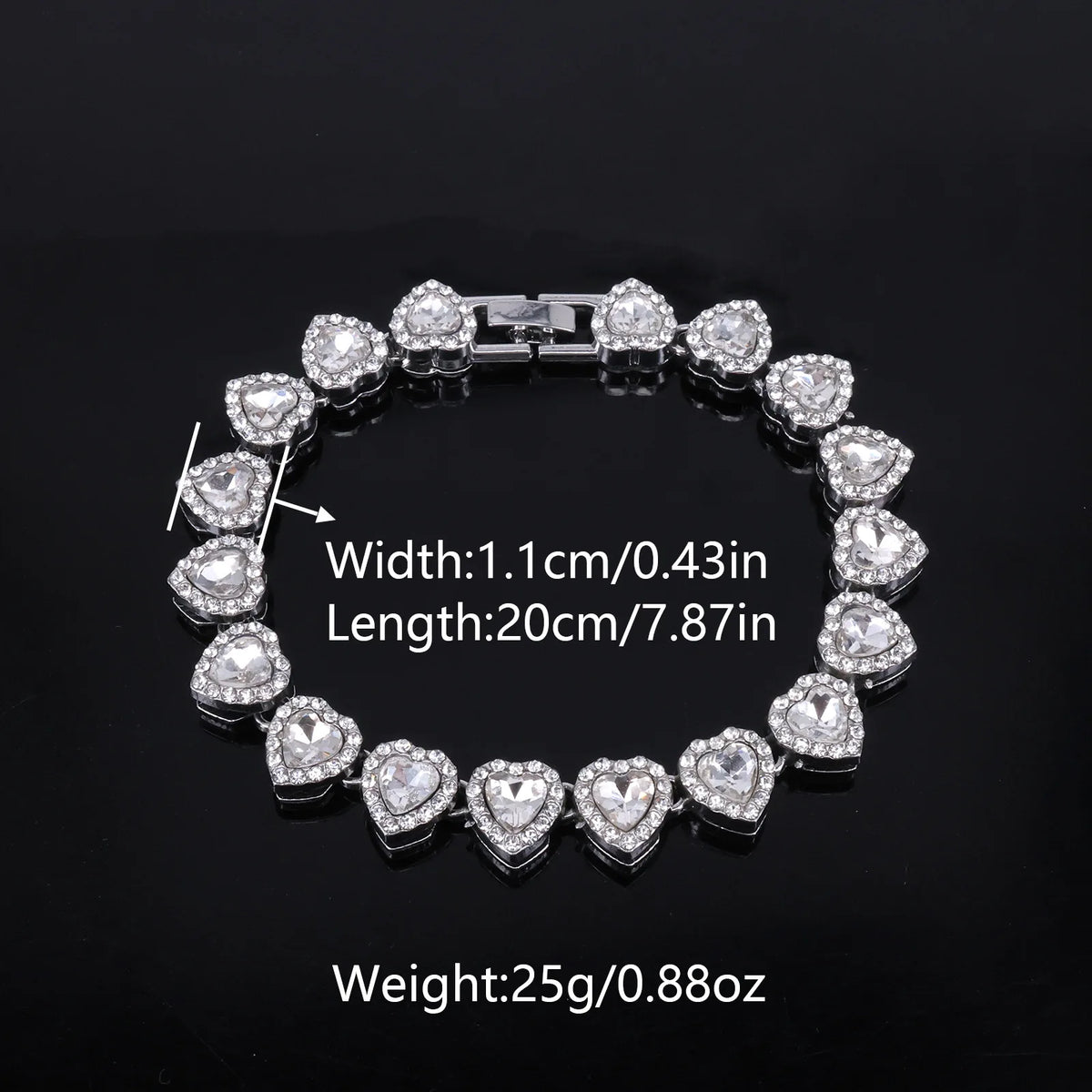 A silver-toned necklace and bracelet set featuring heart-shaped clear rhinestones.