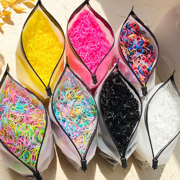 A collection of colorful disposable rubber hair ties in various shades including yellow, pink, and black.