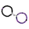 A pair of natural stone heart couple bracelets, one black and one purple, displayed against a white background.