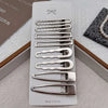 A set of vintage silver Y2K metal hair clips with various shapes and sizes displayed in a white packaging box.