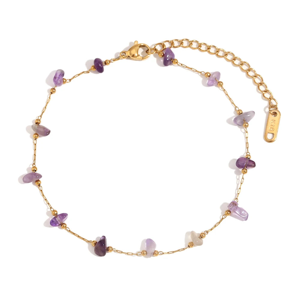 Gold plated foot chains featuring small purple crushed stones.
