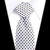 A white shirt with an elegant men's floral paisley silk necktie featuring a black and white checkered pattern.