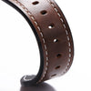 A close-up of a dark brown handmade calfskin leather watch strap curved in an arc.