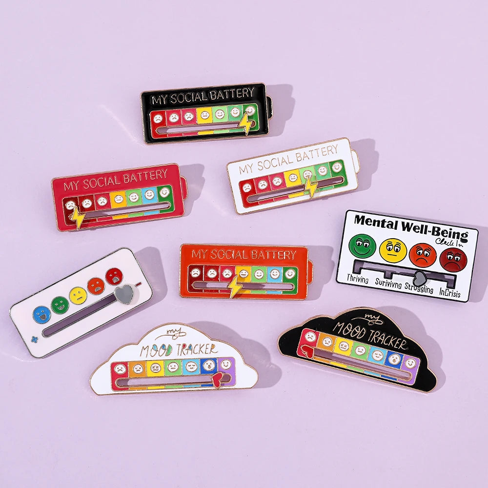 A collection of mood battery pins and a mood tracker pin displayed on a light purple background.