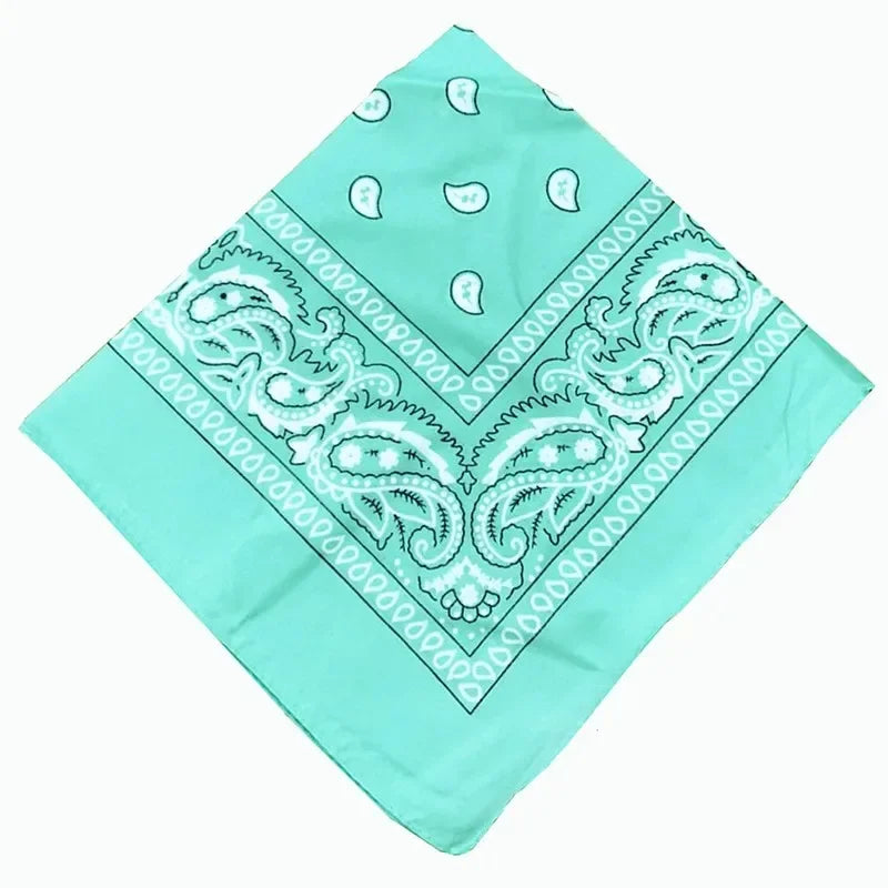 A light turquoise cotton bandana scarf featuring white paisley and geometric patterns.