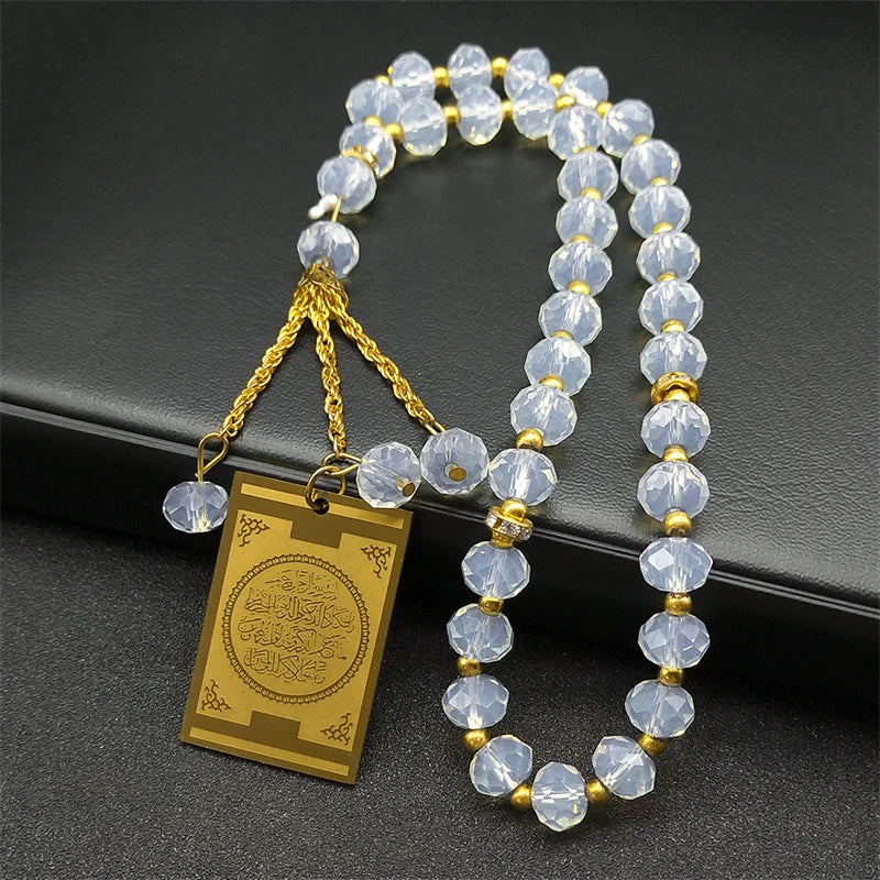 A strand of clear glass beads and a gold-toned pendant necklace for Quran Arabic car jewelry