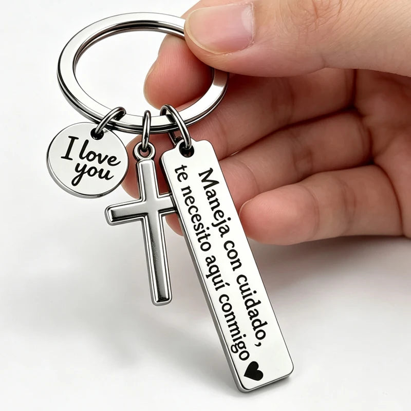 A silver stainless steel couple keychain featuring a 'I love you' charm and a cross pendant.