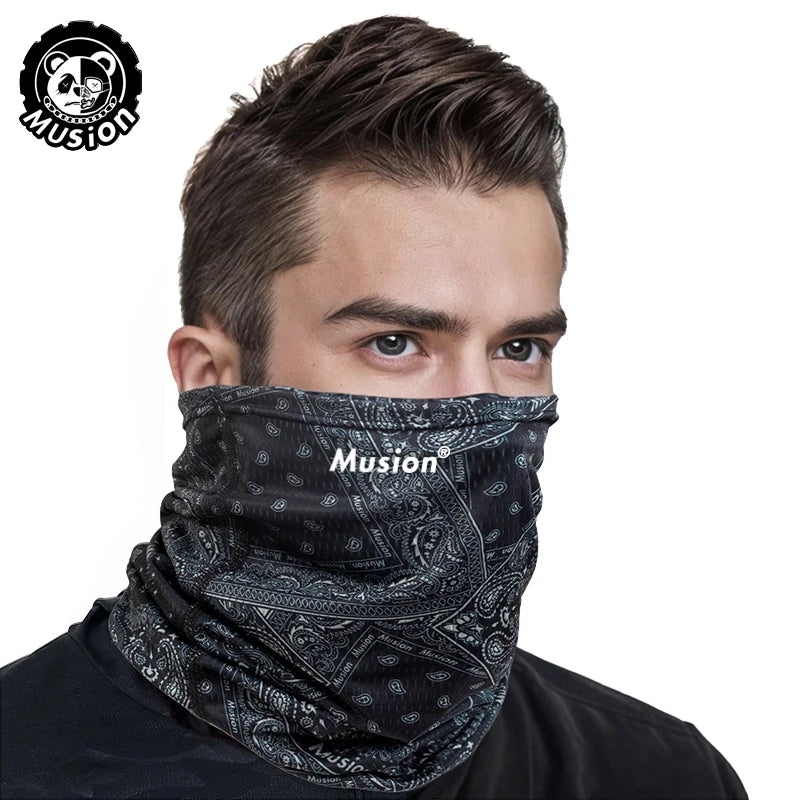 A man wearing a black patterned mask scarf for protection or fashion.