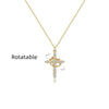 A gold-toned rotatable cross pendant necklace featuring small diamonds.