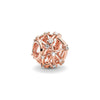 Rose gold charm pendant featuring an intricate, circular design with small clear stones.