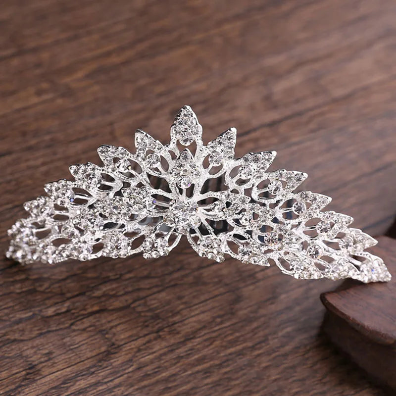 A sparkling crystal princess tiara hair comb for women with intricate floral design.