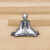 A set of enamel pins featuring a skeleton character design, including a skull and a full skeletal structure.