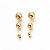 A set of three round stud earrings in gold-toned zinc alloy.