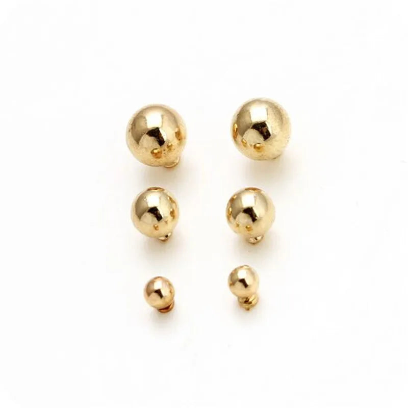 A set of three round stud earrings in gold-toned zinc alloy.