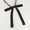 A dark brown ribbon tied in a bow with long tails, suitable for a classic butterfly tie set.