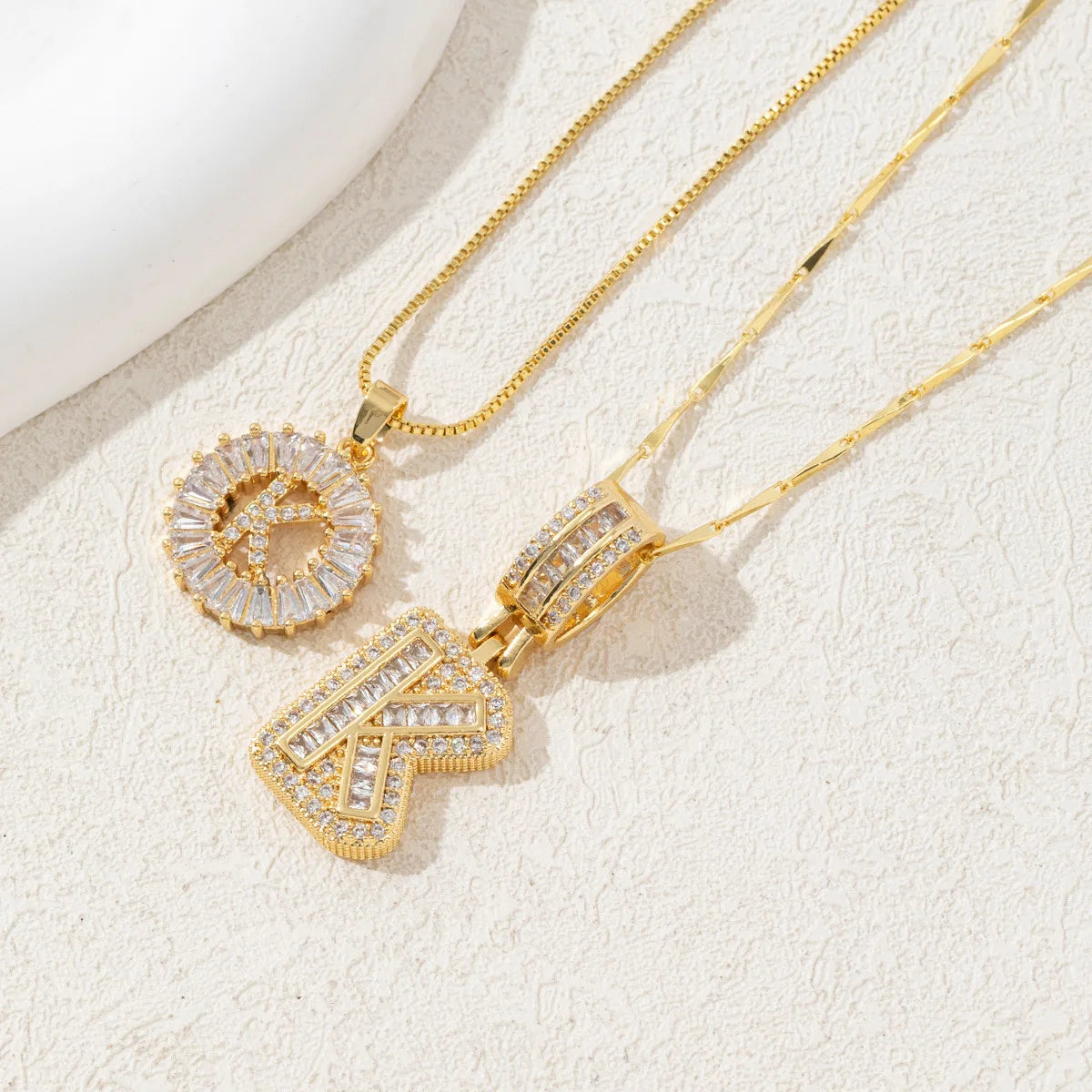 Gold-toned necklace set featuring crystal pendants shaped like the letters A and Z.