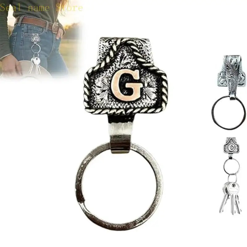 Silver and black letter G pendant on a ring with a leather strap keychain.