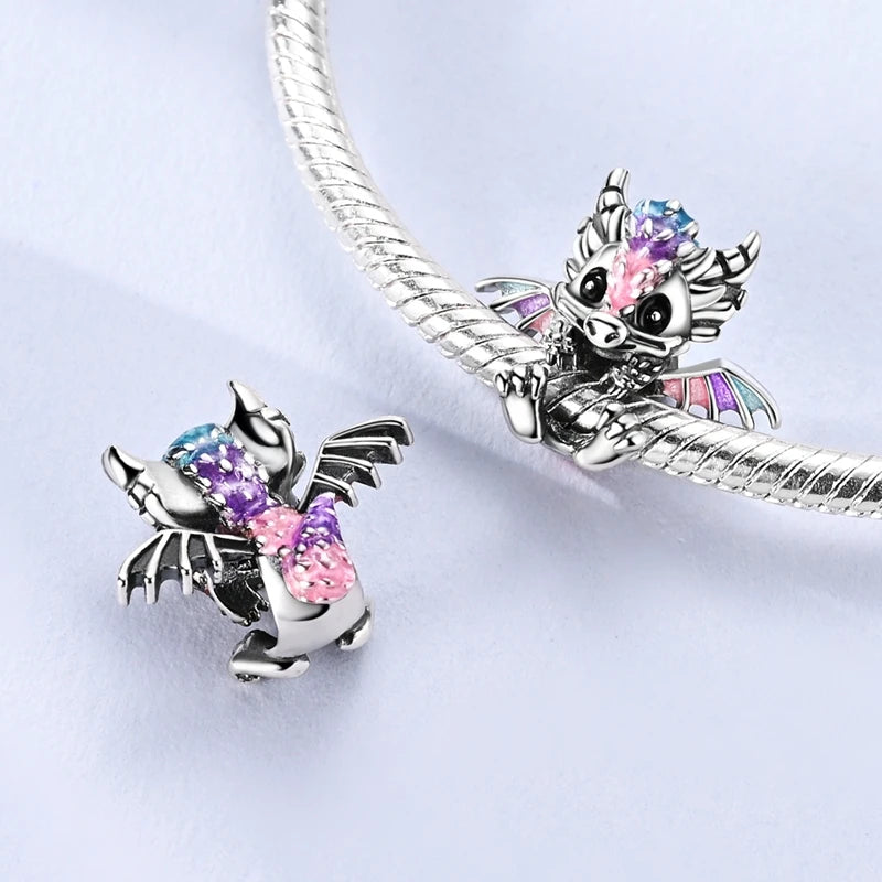 Sterling silver devil's eye charm bracelet featuring a detailed dragon head charm with iridescent stones