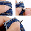 Close-up of a hand using a tool to install punk rock bullet rivets into denim fabric.