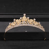 Gold crystal rhinestone bridal tiara headpiece displayed on a black box.