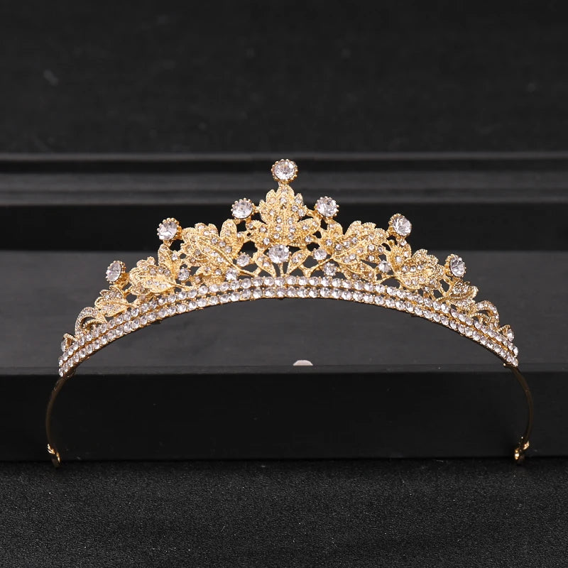 Gold crystal rhinestone bridal tiara headpiece displayed on a black box.