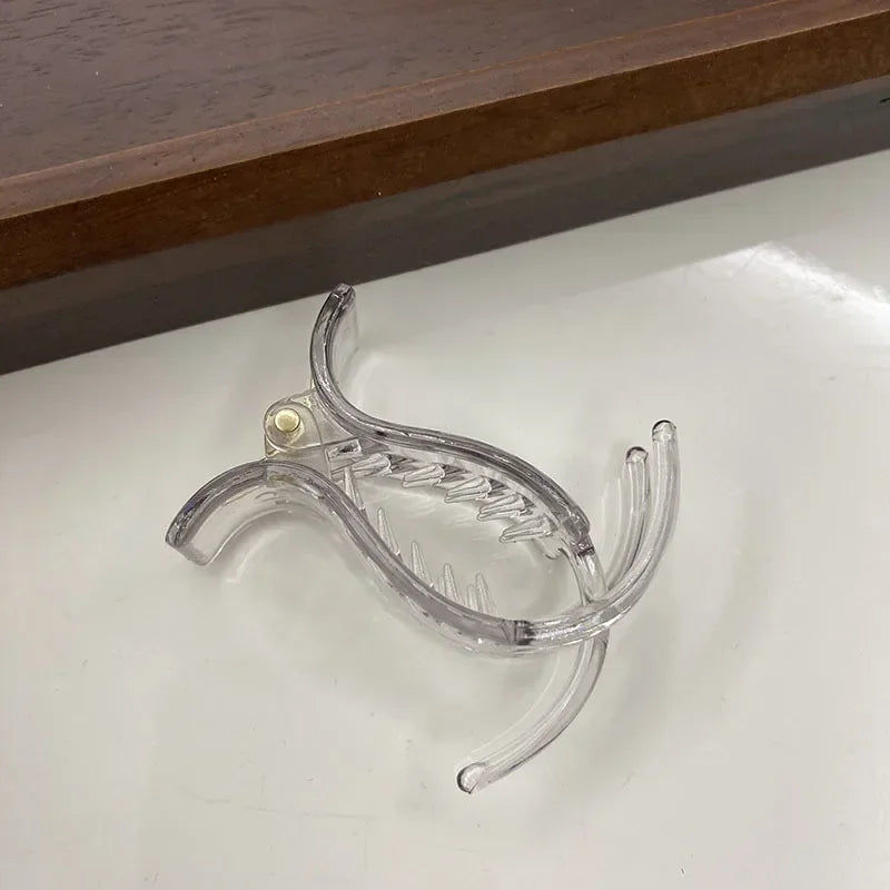Transparent acrylic hair claw used for styling ponytails or hair
