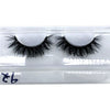 A pair of black natural mink false eyelashes displayed in a clear plastic container.
