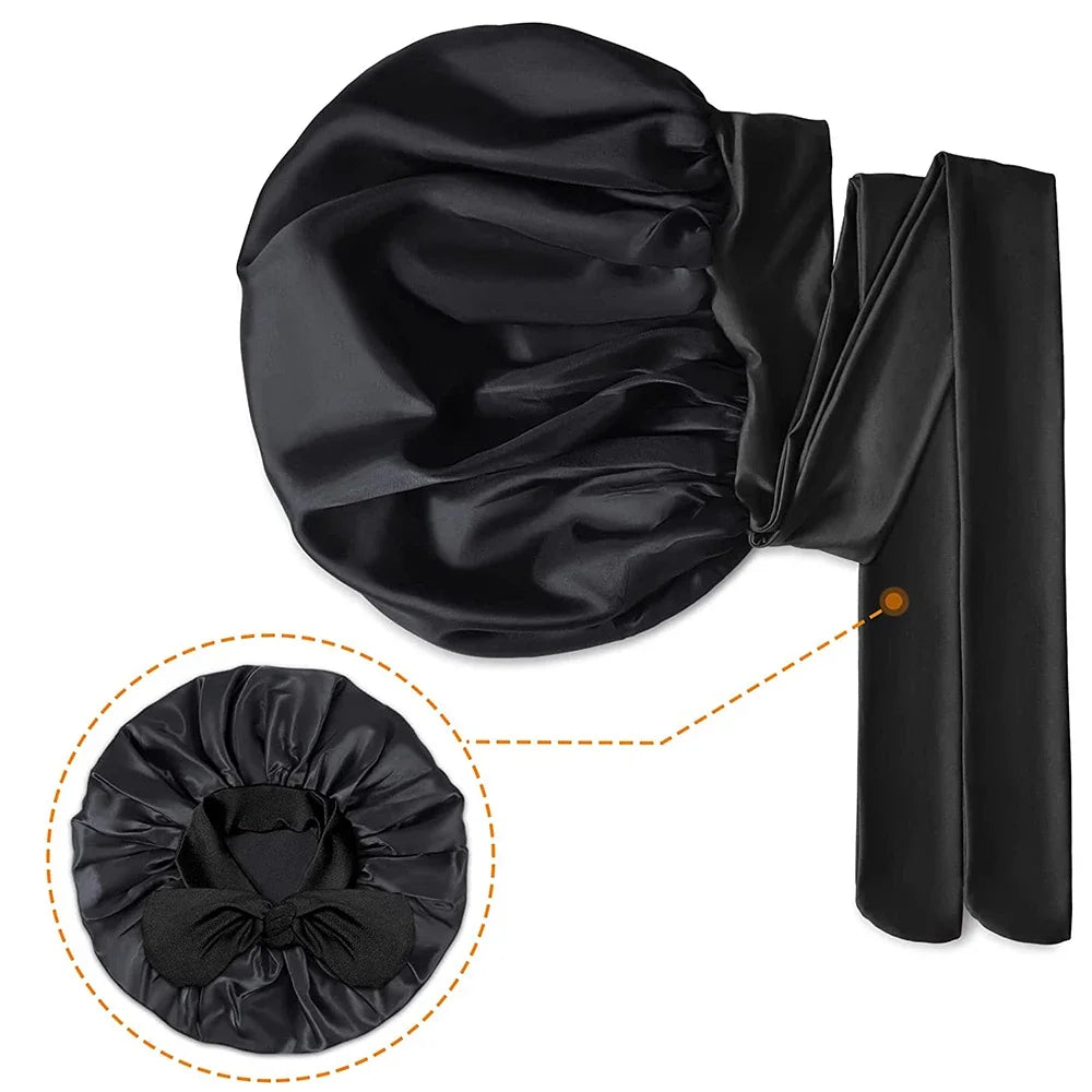 Black mulberry silk sleep bonnet for curly hair shown in a rolled and unfolded state